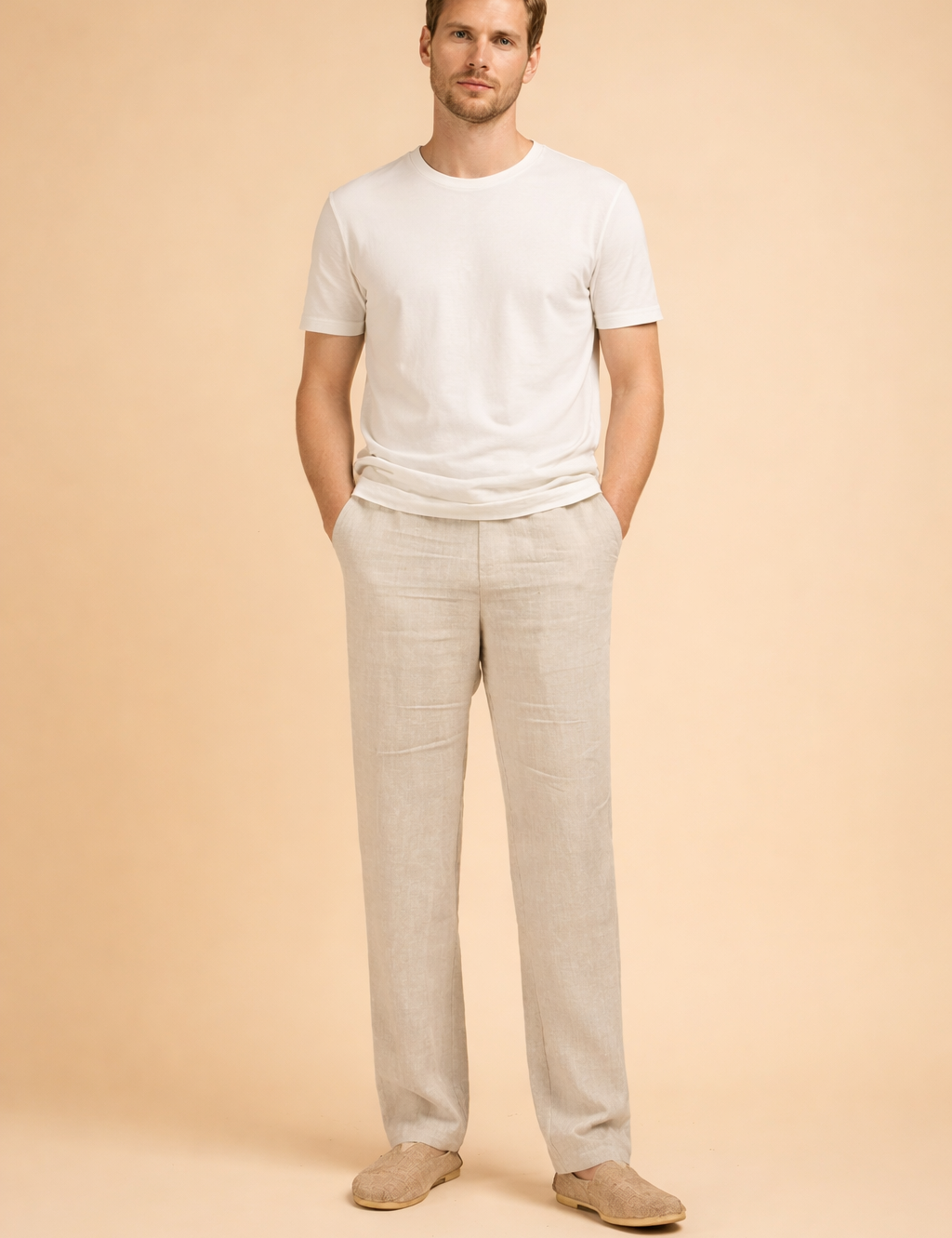 Men’s tailored straight-leg trousers with a relaxed fit, clean front construction, side pockets, and full-length legs styled with minimalist slip-on shoes for a refined everyday look.