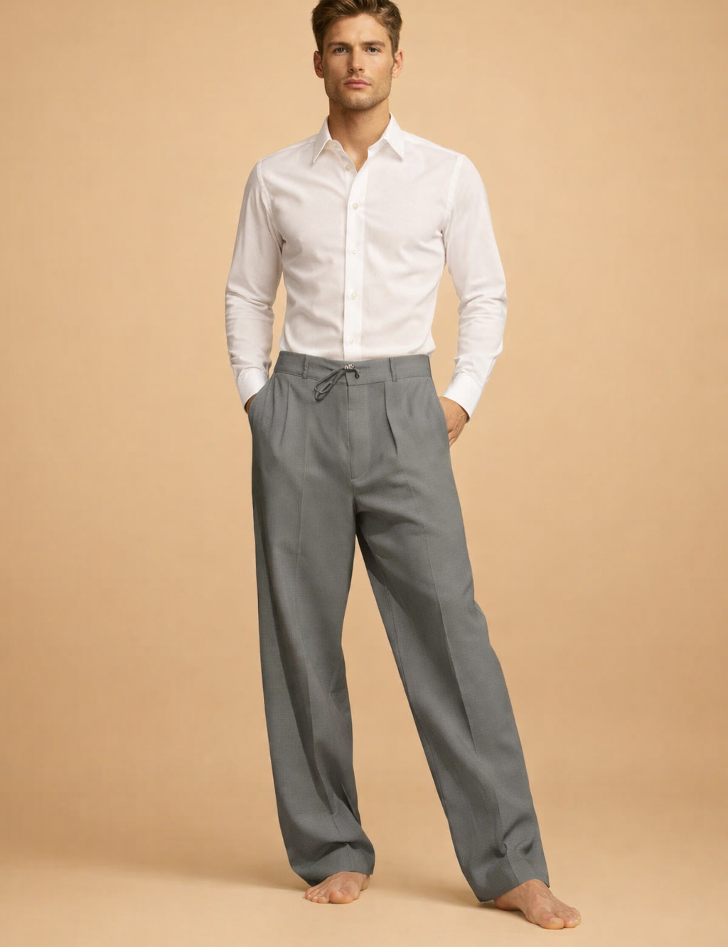 Tailored long-sleeve button-up shirt tucked into relaxed pleated trousers with a drawstring waist and straight-leg cut.