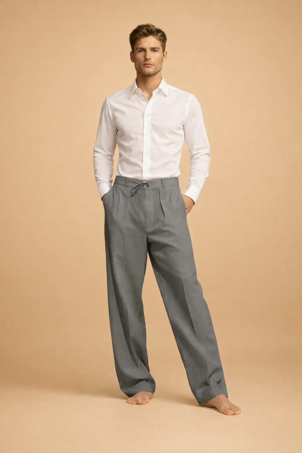 Tailored long-sleeve button-up shirt tucked into relaxed pleated trousers with a drawstring waist and straight-leg cut.