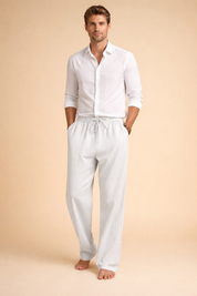 Relaxed straight-leg trousers with an elastic drawstring waist, clean front seam detail, and a fluid full-length cut designed for a refined casual look.