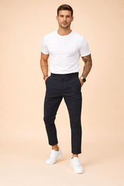 Tailored slim-fit ankle-length trousers styled with a clean short-sleeve top and minimalist low-profile sneakers, featuring a modern tapered leg and refined everyday silhouette.