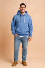 Stylish sky-blue hoodie paired with light denim jeans and tan suede shoes, featuring a clean casual fit with white drawstrings and kangaroo pocket.