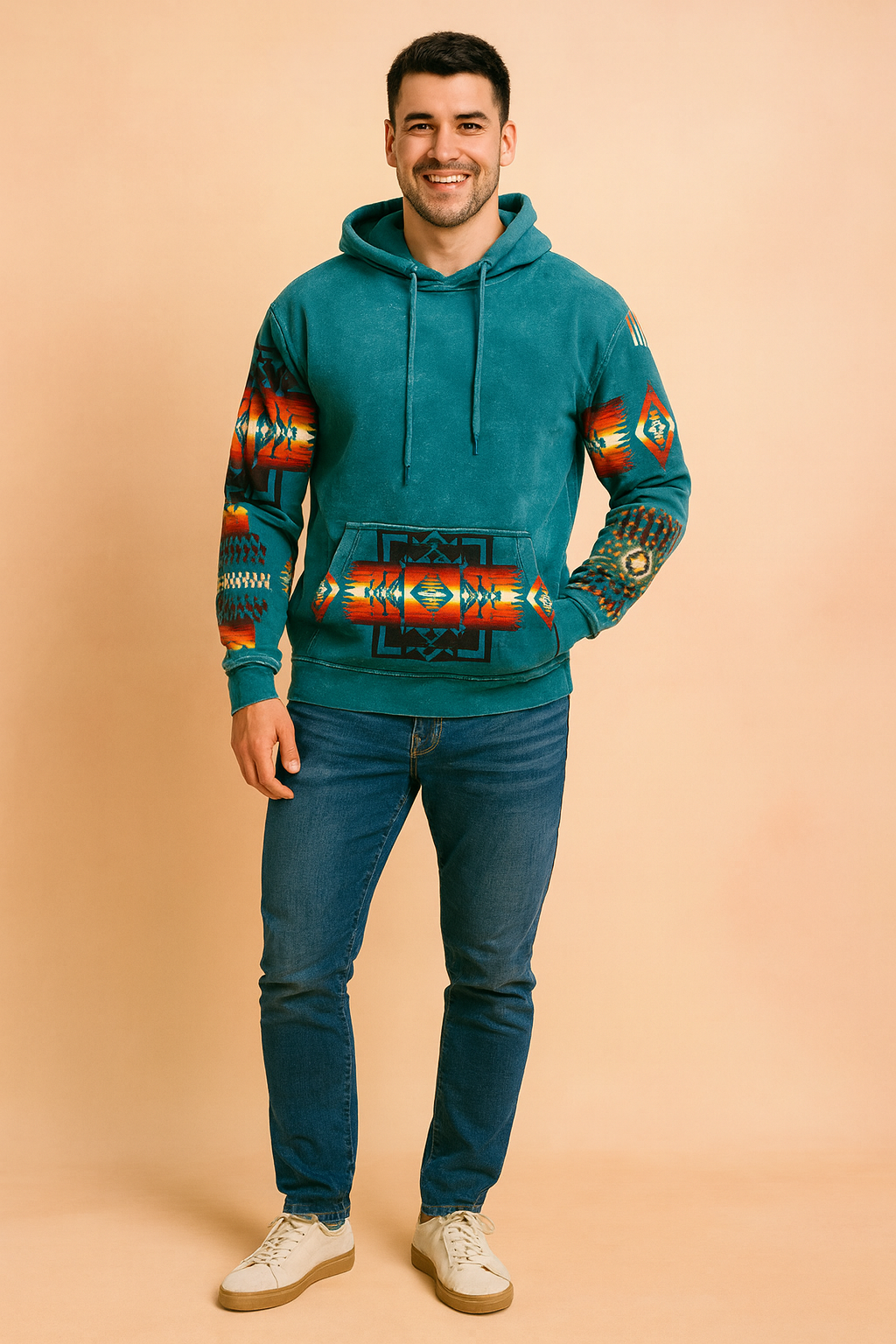 Vibrant turquoise hoodie with bold Southwestern geometric patterns in red, orange, and black on the sleeves and kangaroo pocket, featuring a relaxed fit and drawstring hood.