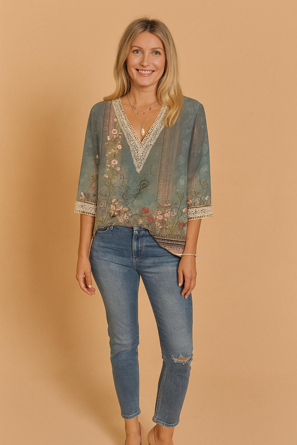 Teal floral print V-neck blouse with lace trim and three-quarter sleeves, featuring a vintage-inspired botanical design and paired with light blue denim jeans.