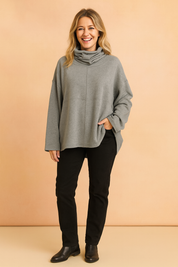 Oversized gray cowl neck sweatshirt with dropped shoulders and long sleeves, made from soft cotton-blend fabric with a relaxed fit and subtle center seam detail.