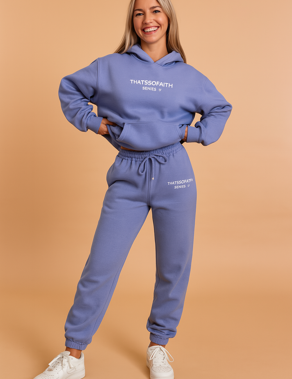 Oversized periwinkle hoodie and jogger set featuring drawstring waist, elastic cuffs, and “THATSSOFAITH SERIES 2” printed branding on both pieces, styled with classic white sneakers.