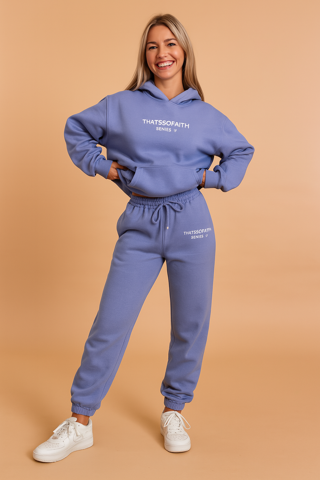 Oversized periwinkle hoodie and jogger set featuring drawstring waist, elastic cuffs, and “THATSSOFAITH SERIES 2” printed branding on both pieces, styled with classic white sneakers.