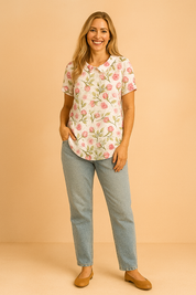 White linen blouse with a Peter Pan collar, detailed with large pink rosebud prints and leafy green stems.