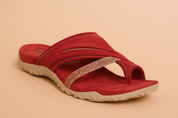 Red suede slip-on sandal with a beige patterned toe loop strap, dual arch bands with zigzag stitching, and a textured beige rubber sole.