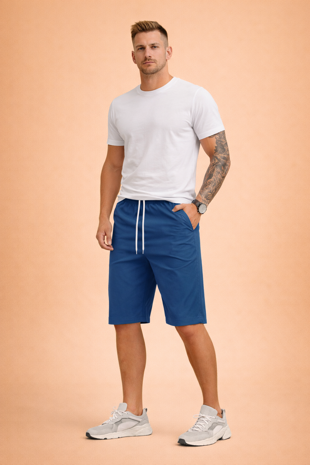 Solid deep blue knee-length casual shorts made from smooth lightweight fabric with an elastic waistband and white adjustable drawstring, featuring a clean matte finish with no pattern or print, paired with a solid olive green short-sleeve crew and white low-top athletic sneakers with breathable mesh panels and cushioned rubber soles.