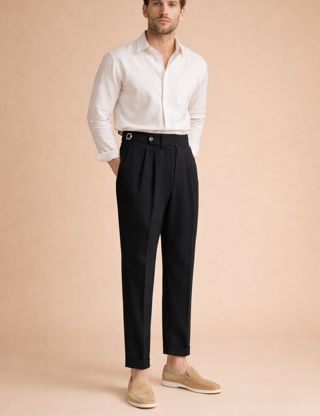 Elegant pleated trousers with a defined high-rise waist, side adjuster detail, front fastening, sharp crease lines, straight-to-tapered silhouette, and ankle-length finish paired with a refined long-sleeve shirt and slip-on loafers.