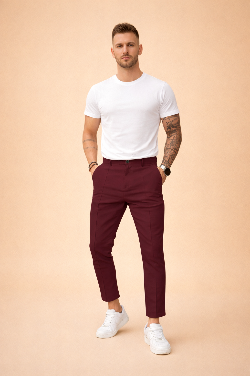 Slim-fit tailored trousers with clean front crease, mid-rise waist, belt loops, button closure, side pockets, tapered leg, ankle-length finish, styled with a tucked-in short-sleeve top and low-profile sneakers.