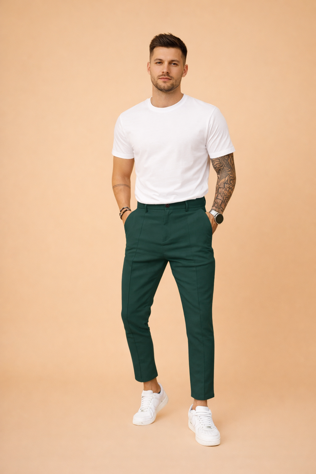 Tailored slim-fit trousers styled with a clean short-sleeve top and minimalist low-profile sneakers, creating a modern smart-casual outfit with a refined, structured silhouette.