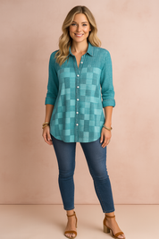 Women's casual outfit featuring a checkered button-up brown shirt with 3/4 sleeves, paired with high-waisted blue skinny jeans and white low-top sneakers.