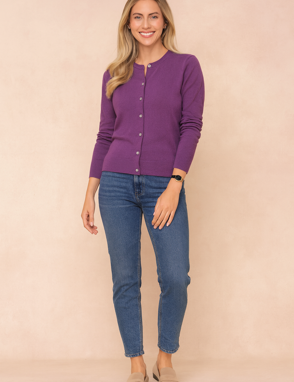 Purple button-front cardigan paired with medium blue skinny jeans and beige suede loafers.