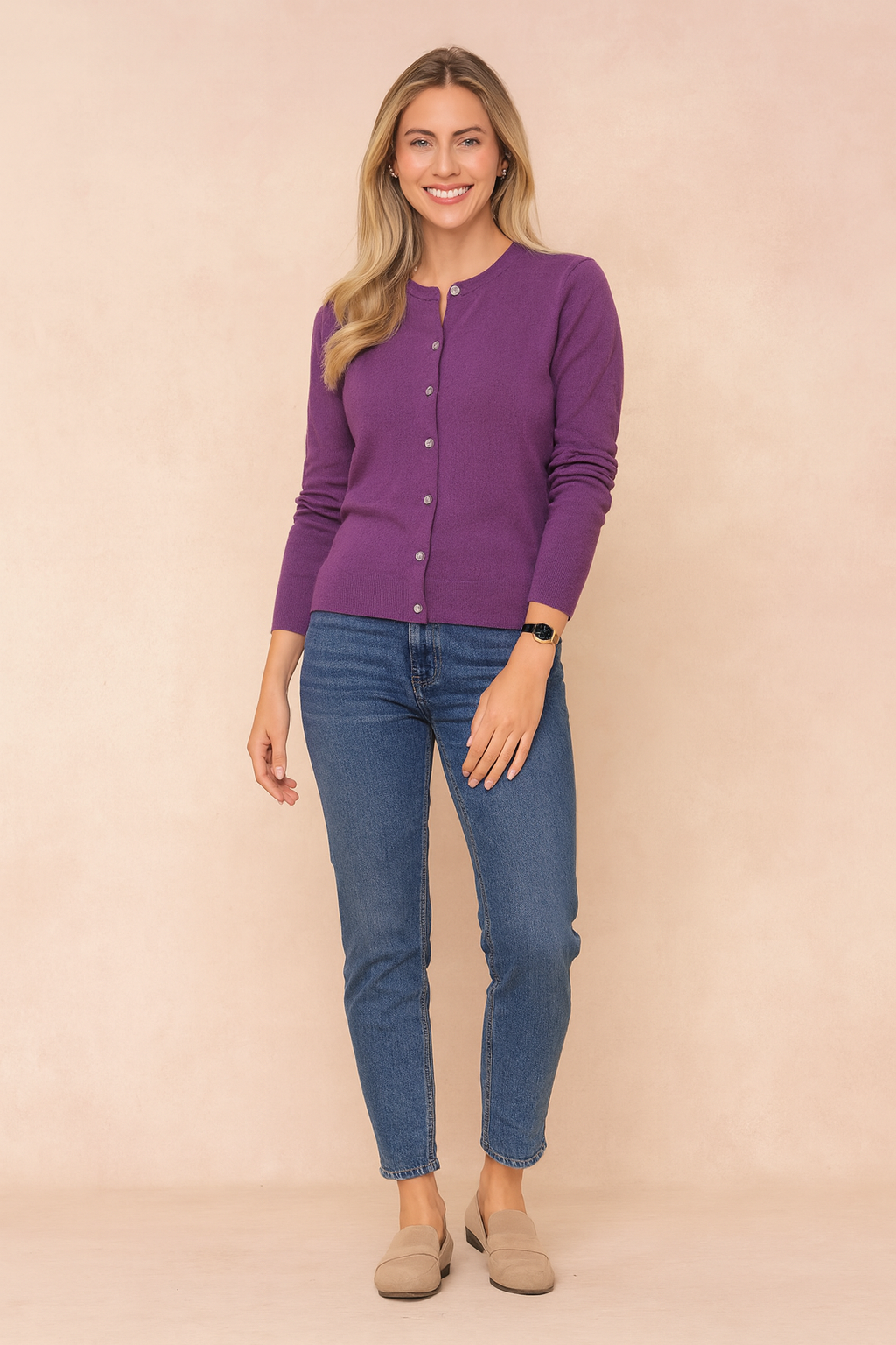 Purple button-front cardigan paired with medium blue skinny jeans and beige suede loafers.