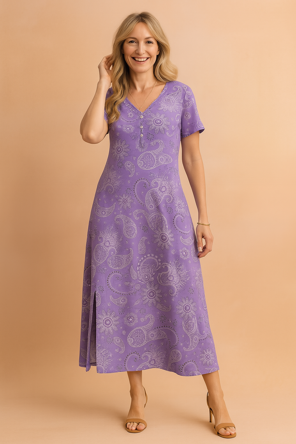 Maxi-length purple paisley dress featuring a V-neckline, short sleeves, subtle front buttons, and a side slit, styled with high-heeled sandals for a breezy, effortless summer look.