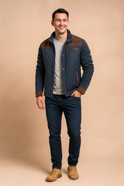 Quilted navy jacket with brown corduroy shoulder panels, cuffs, and trim, featuring a diamond-stitched design and front button closure.