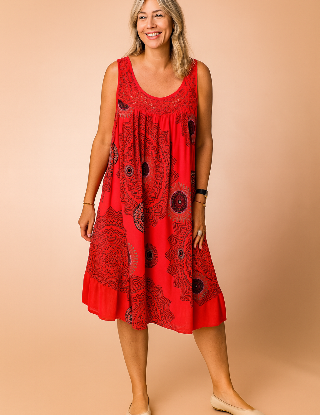Sleeveless red sundress featuring bold black mandala-style circular prints, gathered scoop neckline, and an airy A-line silhouette designed for a relaxed, breezy fit.
