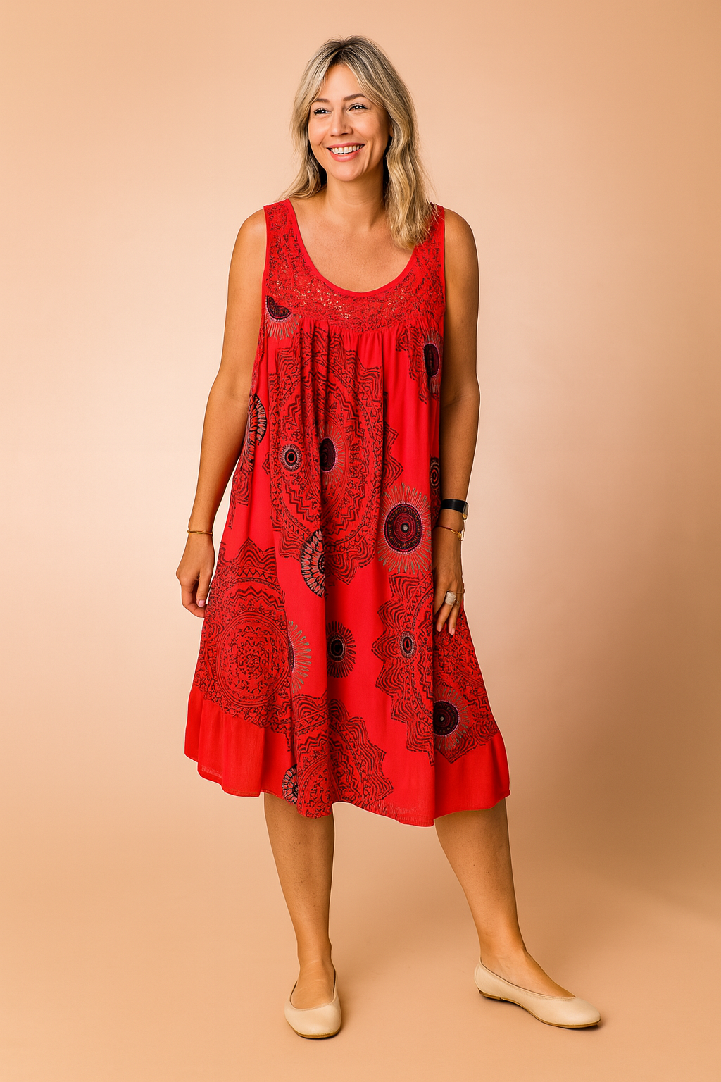 Sleeveless red sundress featuring bold black mandala-style circular prints, gathered scoop neckline, and an airy A-line silhouette designed for a relaxed, breezy fit.