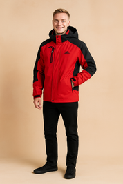 Red and black hooded outdoor jacket with multiple zippered pockets, adjustable cuffs, and weather-resistant fabric, paired with slim black pants and black sneakers.
