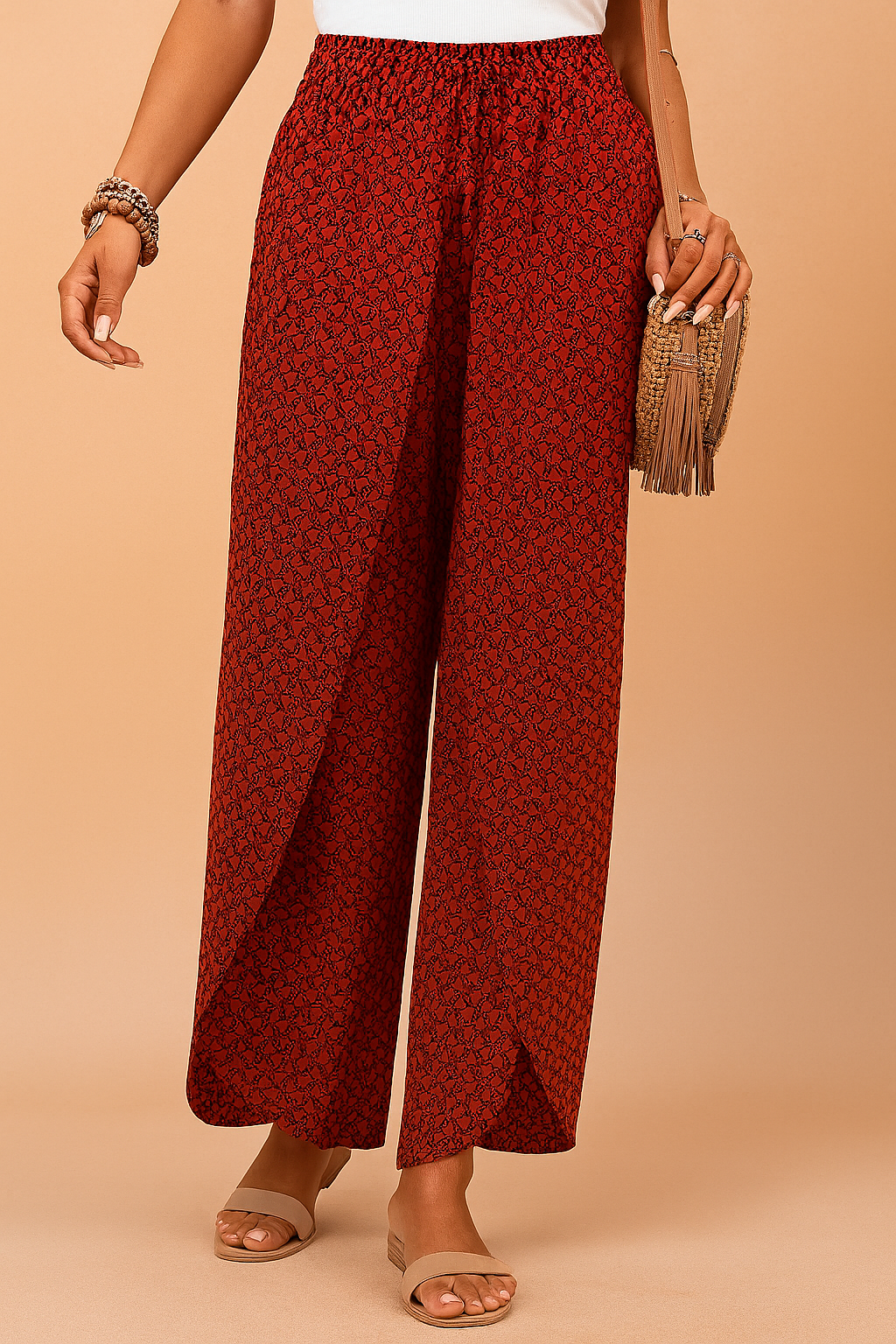 High-waisted red wide-leg pants with a black herringbone-style geometric pattern, featuring an elastic waistband and front drawstring in matching fabric, made from lightweight woven material with a natural drape.