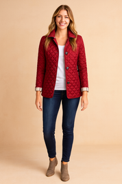 Red quilted button-down jacket with diamond pattern, styled over a white top, dark jeans, and ankle boots.