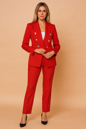 Bold red tailored pantsuit featuring a double-breasted blazer with silver embossed buttons and matching slim-fit trousers, paired with a white scoop-neck inner top.