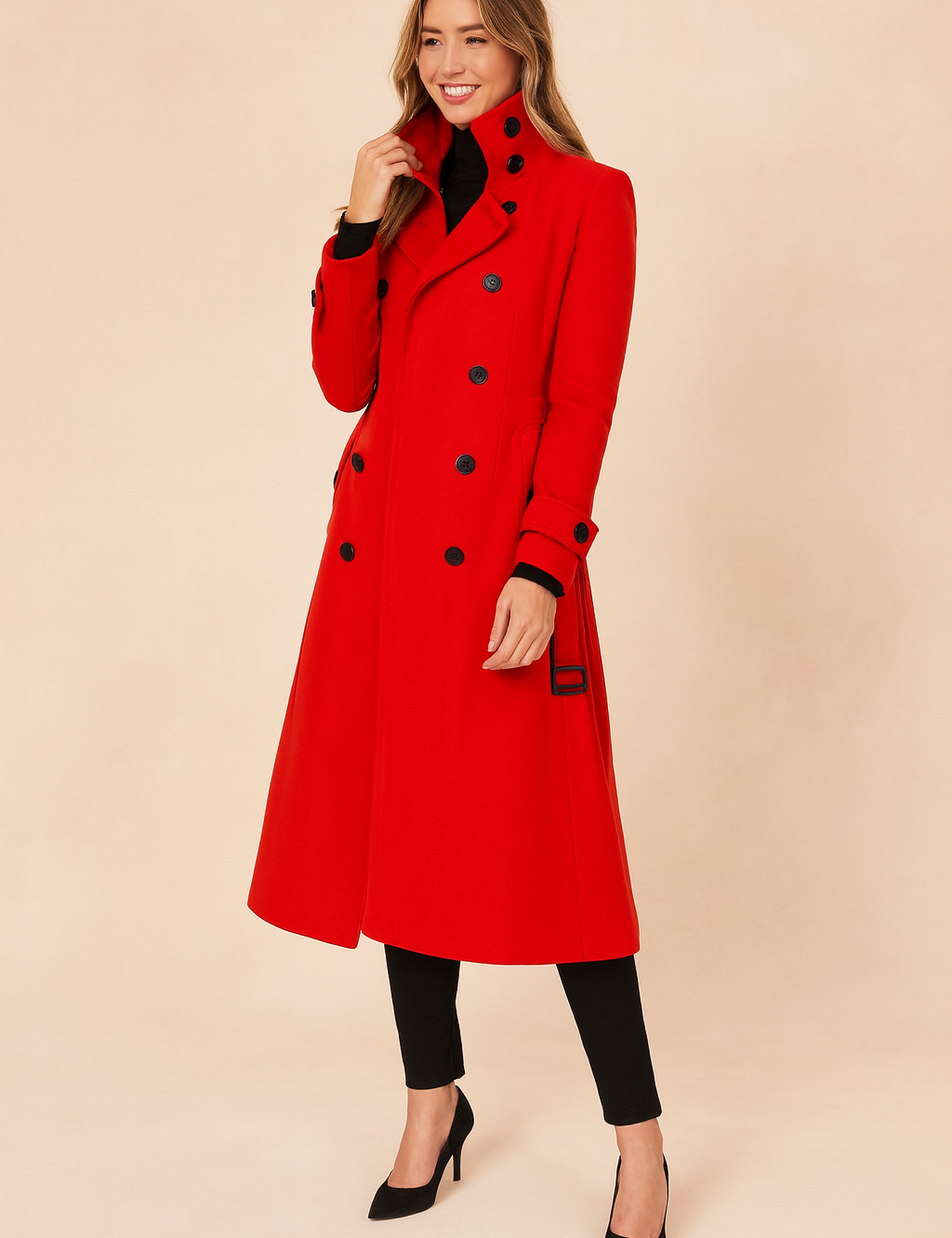 Bright red trench coat with stand-up collar, black button detailing, cuff straps, and belted sides, styled over black trousers and black pointed-toe heels.