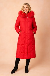 Long red quilted winter parka with fur-trimmed hood, front zipper, and side pockets.