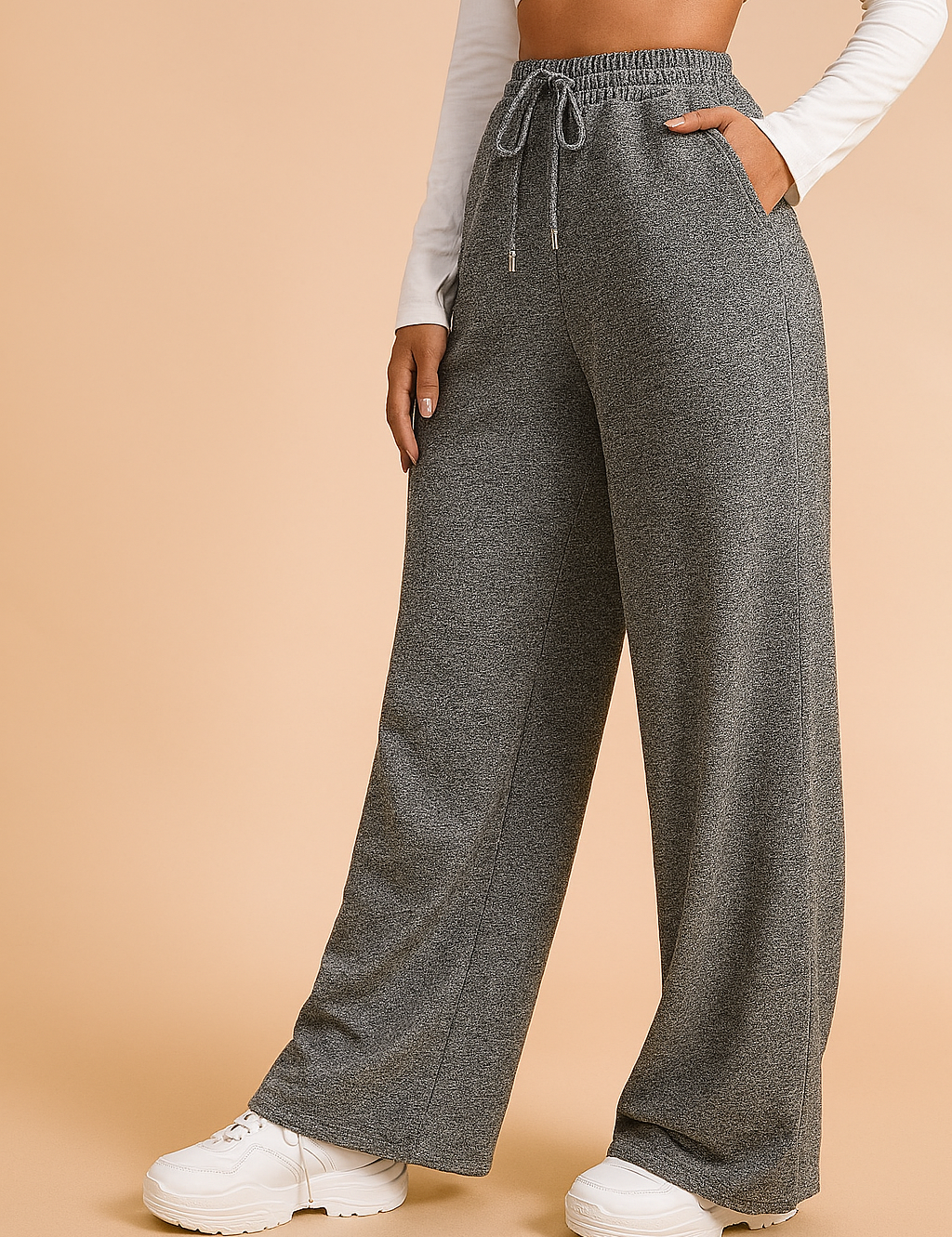 Wide-leg heather gray sweatpants with a drawstring waist and side pockets, styled with a white long-sleeve crop top and chunky white sneakers.