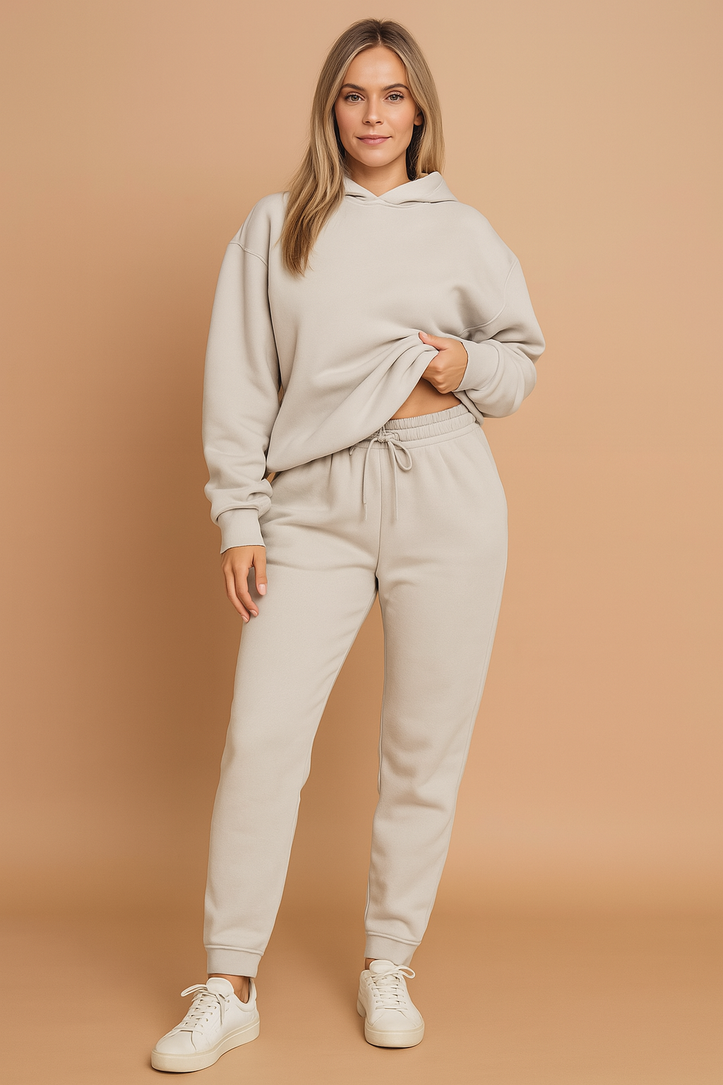 Light grey fleece hoodie and matching jogger sweatpants set made from soft brushed cotton with a relaxed fit, featuring elastic cuffs, an adjustable drawstring waistband, and a cozy hood.