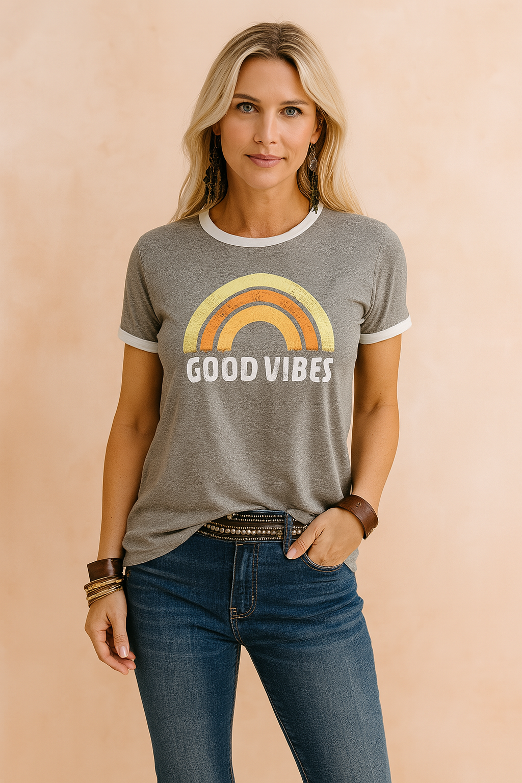 Vintage-style women's graphic tee with retro rainbow print and "Good Vibes" slogan, paired with dark blue denim jeans and statement boho bracelets—ideal for casual fashion-forward looks.