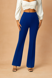 High-waisted royal blue flare pants with center seams and a structured silhouette, styled with black open-toe heels.