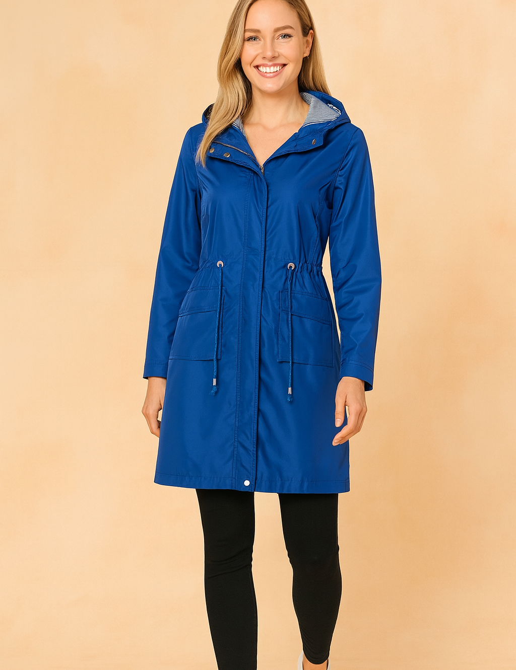 Royal blue hooded raincoat with striped inner lining, drawstring waist, front flap pockets, and buttoned cuffs, styled with a sleek full-length design.