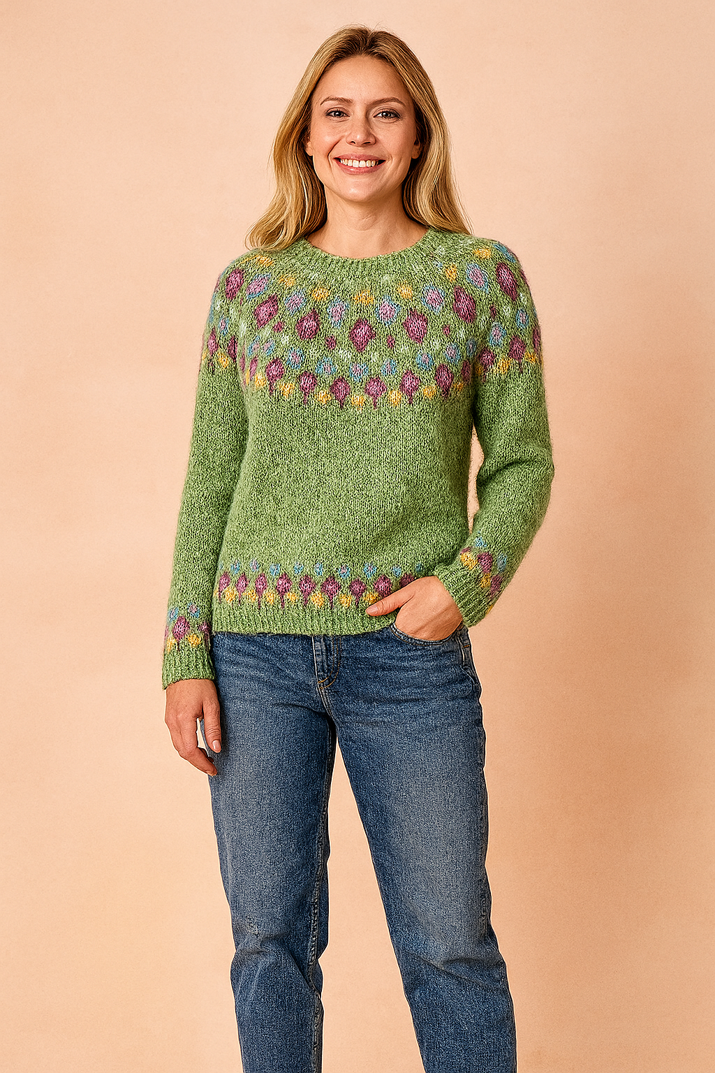 Sage green Fair Isle knit sweater with multicolored diamond pattern across yoke and cuffs, paired with classic blue jeans.