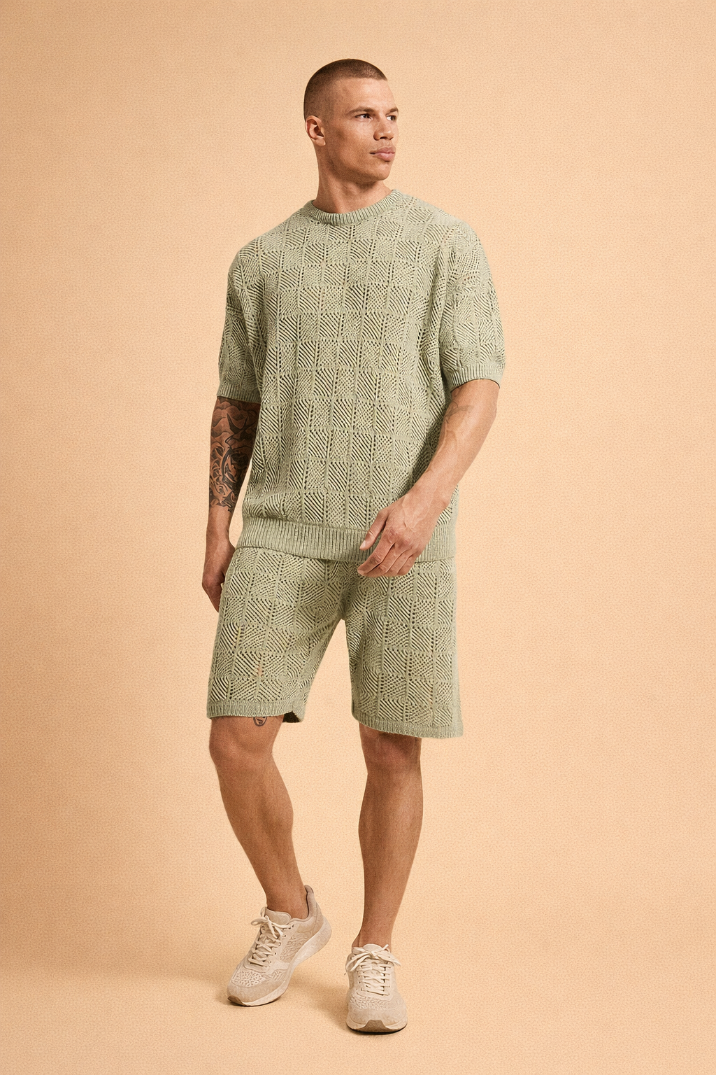 Sage green knitted short-sleeve sweater and matching knit shorts set featuring an all-over geometric openwork pattern, ribbed crew neckline, ribbed sleeve cuffs, ribbed hem, elastic waistband shorts, breathable textured fabric, and coordinated relaxed-fit summer knit co-ord design