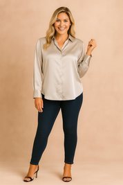 Classic champagne satin blouse with a button-down front, pointed collar, long sleeves, and wide cuffs, styled with dark wash skinny jeans.