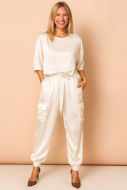 Two-piece satin co-ord set featuring a relaxed-fit blouse with elbow-length sleeves and drawstring high-waist cargo pants with flap pockets and elastic cuffs.