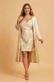 Elegant two-piece coord set featuring a satin cowl-neck mini slip dress and a matching long duster coat with delicate wildflower and botanical print, styled with precision tailoring and a smooth silk finish.