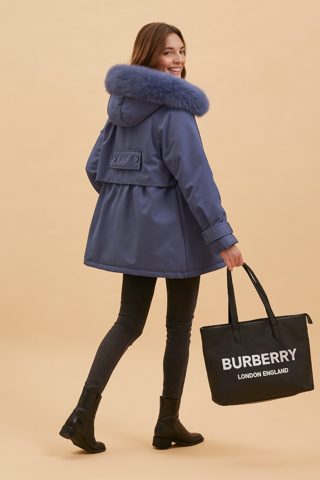 Slate blue hooded parka with plush faux fur trim, belted back detail, adjustable cuffs, paired with slim dark grey leggings and black ankle boots, styled with a black Burberry tote bag.