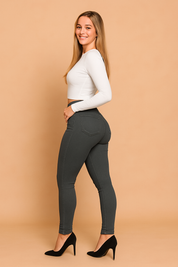 High-waist slim-fit jeggings in deep gray, featuring a sleek front button closure, defined seams, and a flattering stretch fabric that enhances shape while ensuring comfort.