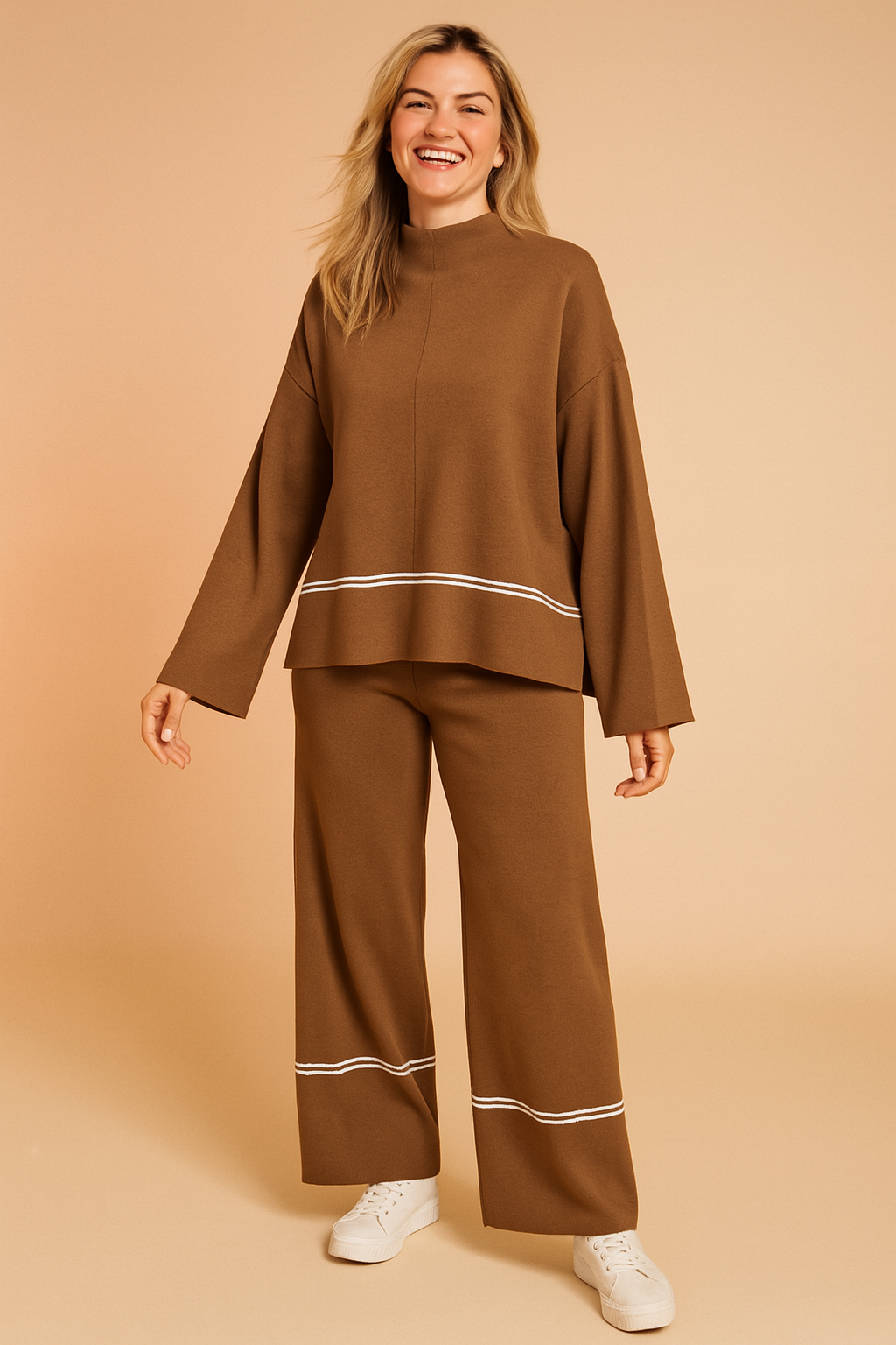 Cozy camel brown two-piece knit lounge set with white piping detail on the hem of the oversized top and near the cuffs of the wide-leg pants, crafted from soft jersey knit fabric for casual comfort.
