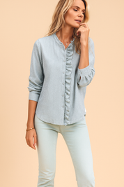 Women's blue and white striped ruffle button-down blouse with textured fabric and casual rolled sleeves, ideal for chic everyday styling.