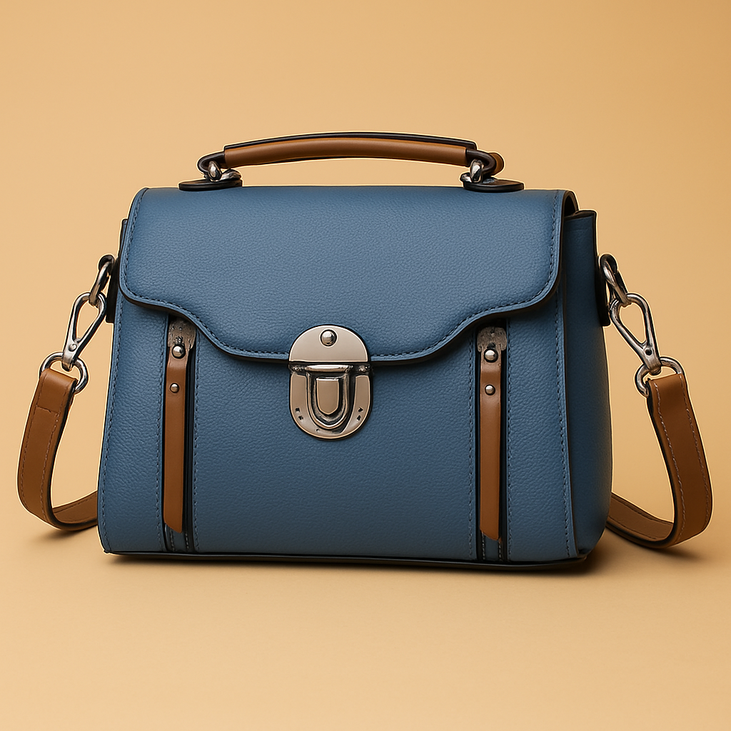 A structured blue handbag with brown accents and silver clasp, showcased against a pastel gradient background transitioning from pink to warm sand.