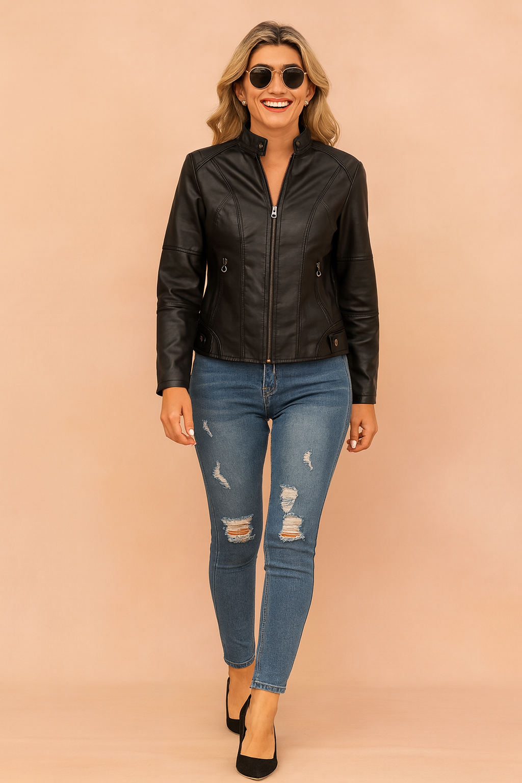 Black faux leather zip-up jacket with silver hardware, paired with distressed blue skinny jeans and black closed-toe heels.