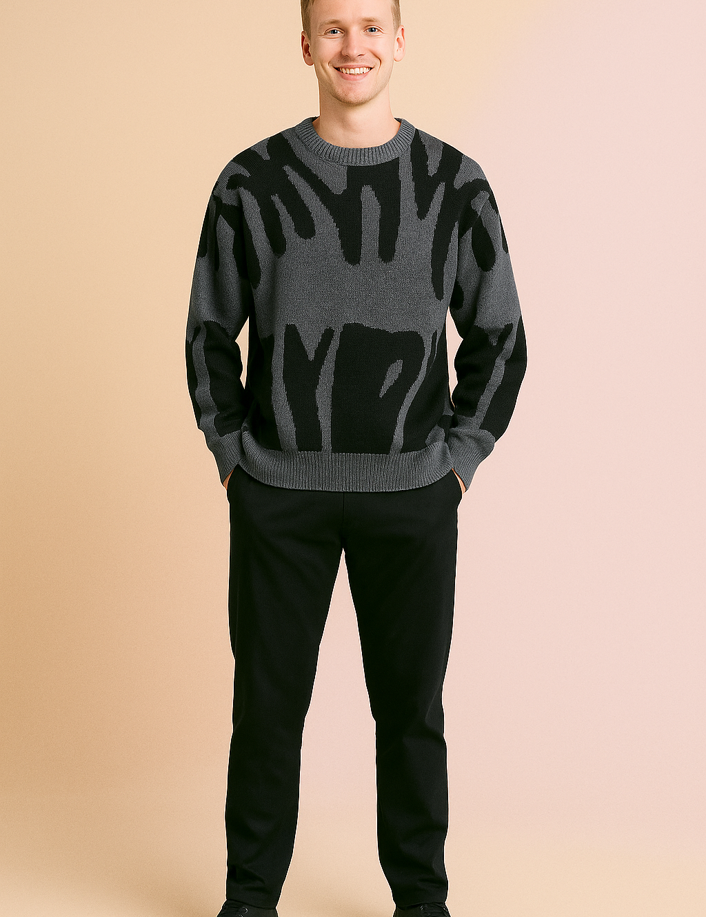 Gray crewneck sweater with bold abstract black patterns, soft knit fabric, relaxed fit, styled with black trousers and black sneakers.
