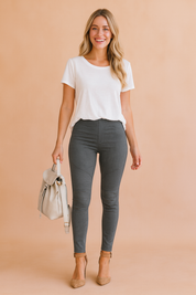 Stylish women’s grey jeggings with ribbed thigh detailing, slim fit cut, and ankle-length design paired with taupe heels and a casual white top.