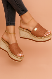 Fashion-forward women's wedge sandals featuring a terracotta textured fabric upper, wide slip-on band with gold-tone accent, braided jute midsole, and sturdy platform espadrille heel.