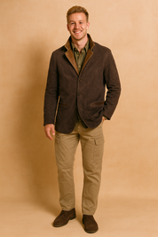 Dark brown suede blazer with leather-trimmed lapels, button-front closure, and welt pockets, styled with an olive green shirt, beige cargo pants, and dark brown suede shoes.